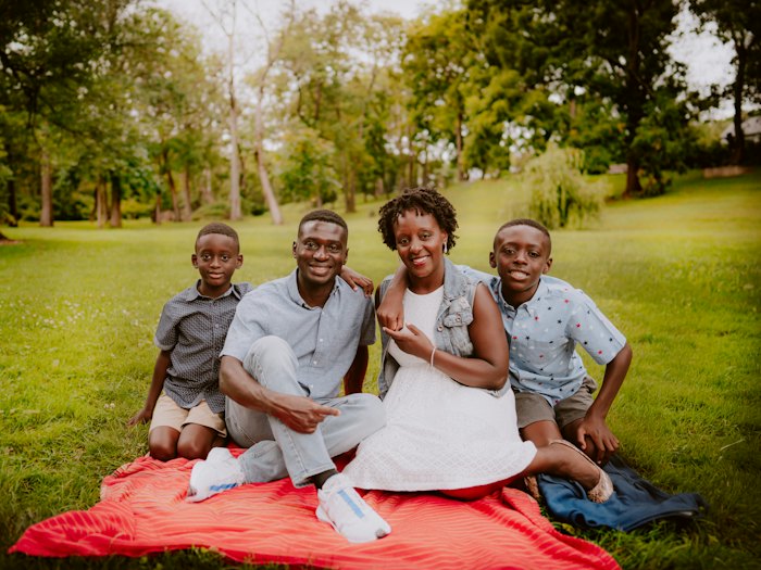 A family sitting together on a picnic blanket