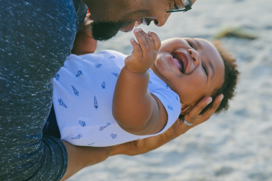 A father lifting his laughing baby